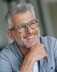 Middle-aged man in grey shirt with perfect smile