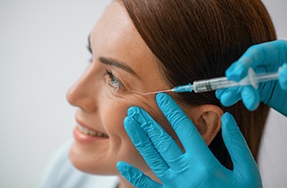 A woman getting BOTOX in her crows feet