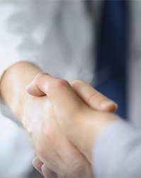 Patient and emergency dentist in Boston, MA shaking hands