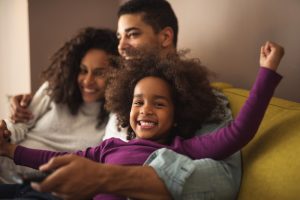 family embracing on sofa