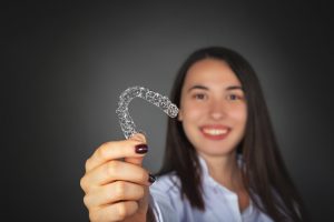 woman holding invisalign tray