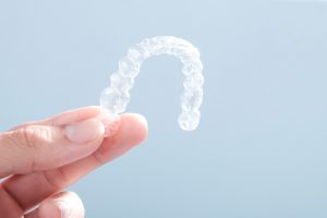 invisalign aligner against blue background