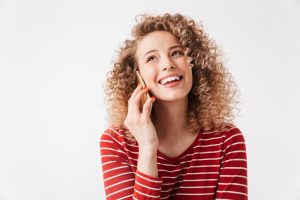 woman smiling speaking on the phone