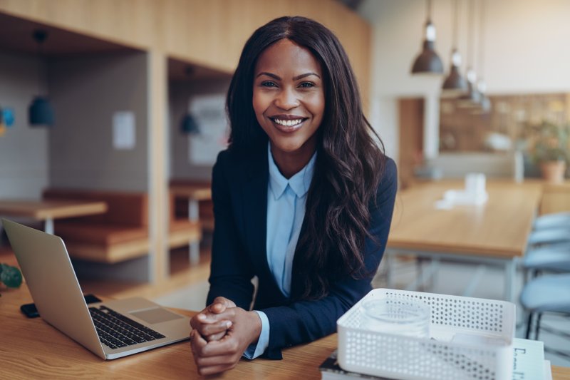 Businesswoman smiling after teeth whitening