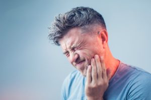 a patient suffering from tooth pain in Boston