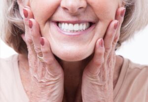 Senior smiling with dentures.
